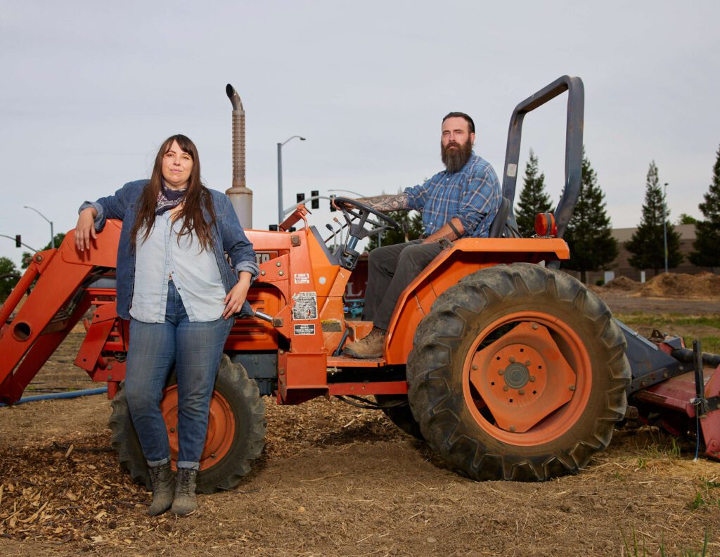 Man and woman by a tractor